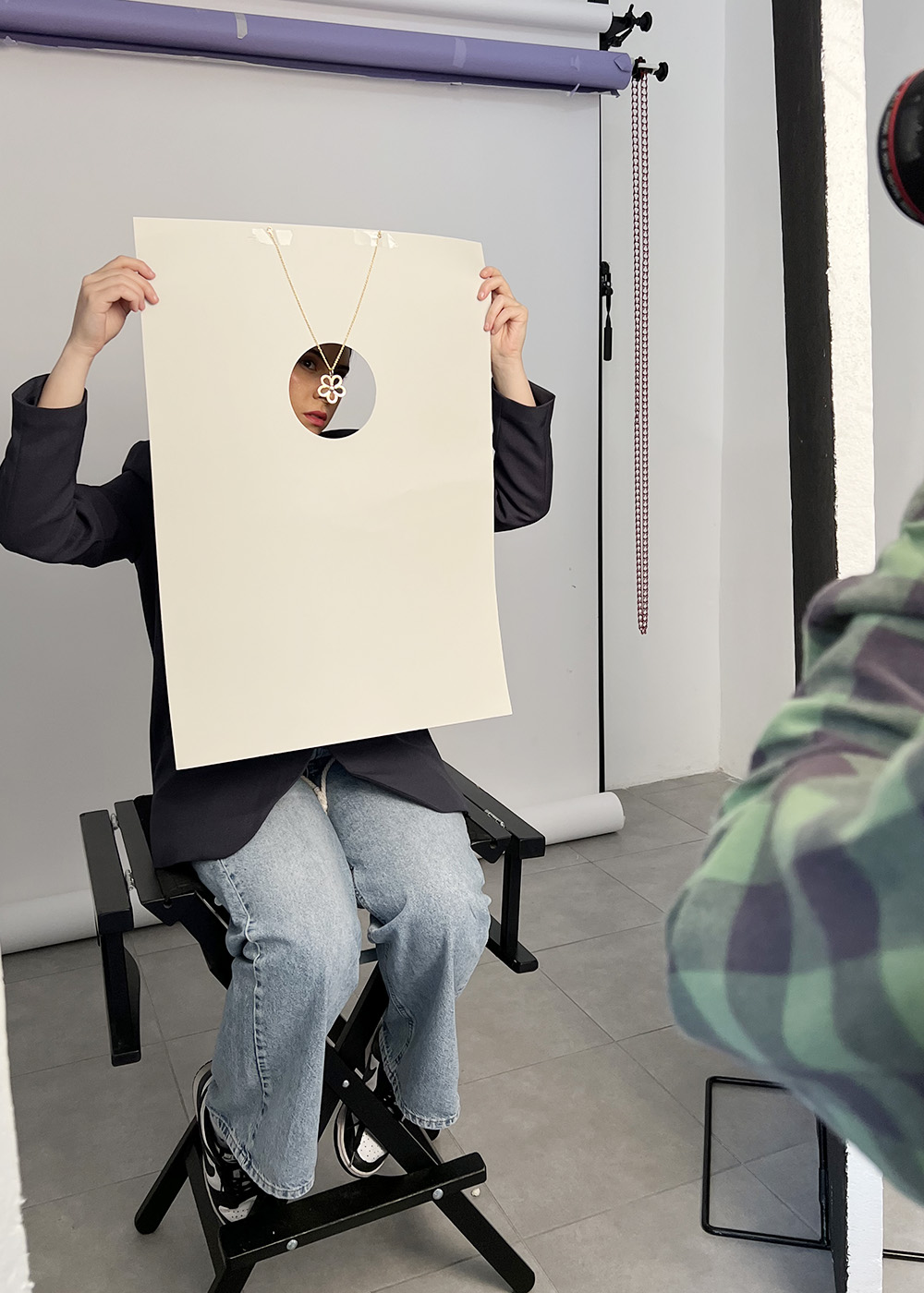 Behind-the-scenes moment showing styling and lighting setup for jewelry photography.